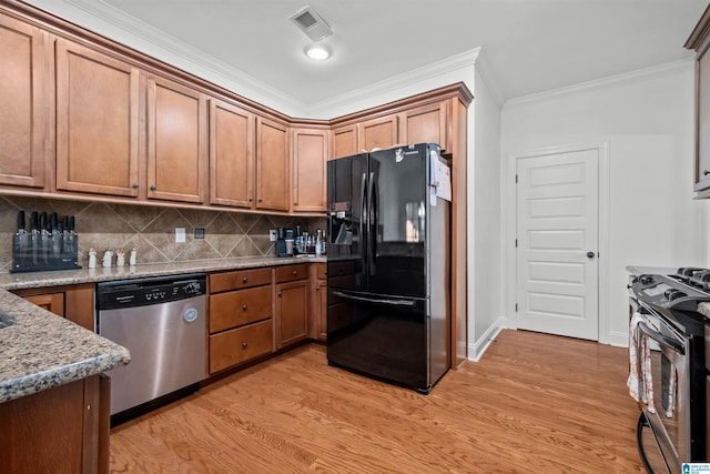 kitchen featuring light stone countertops, appliances with stainless steel finishes, light hardwood / wood-style floors, and ornamental molding