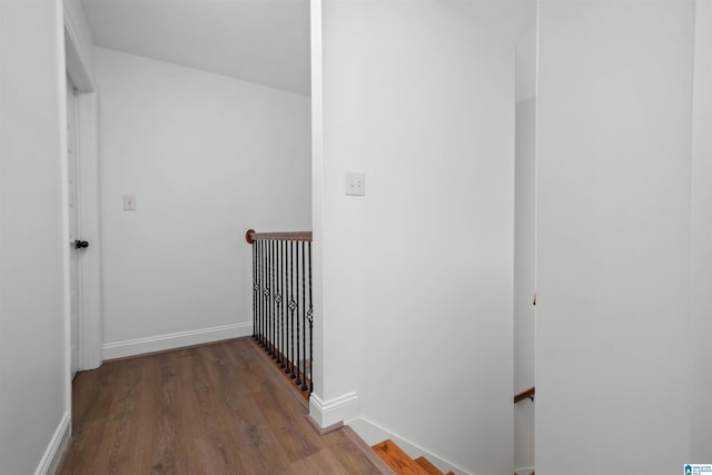 hallway with hardwood / wood-style floors