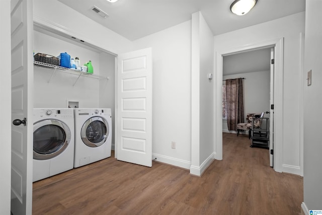 washroom featuring washer and dryer and hardwood / wood-style flooring