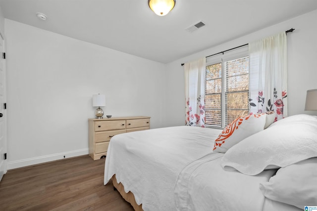 bedroom with dark wood-type flooring