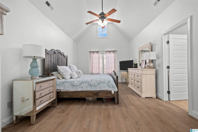 bedroom with ceiling fan, high vaulted ceiling, and hardwood / wood-style flooring