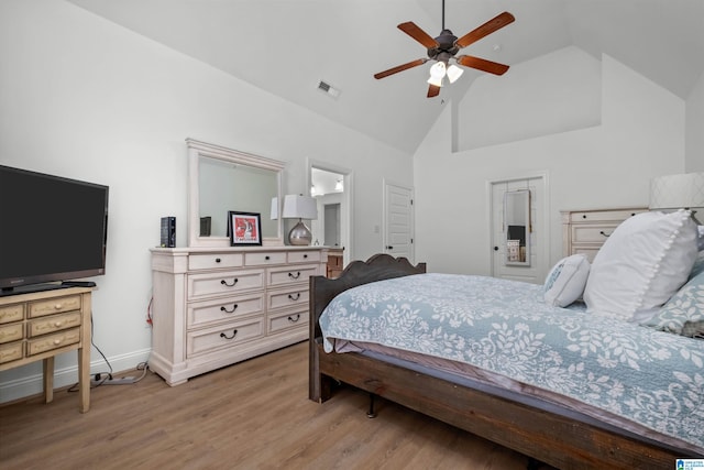 bedroom featuring light hardwood / wood-style floors, high vaulted ceiling, and ceiling fan