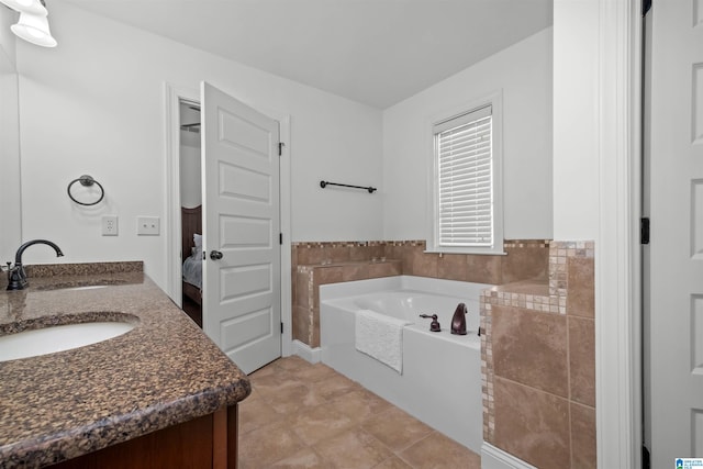 bathroom featuring tile patterned floors, a bathtub, and vanity