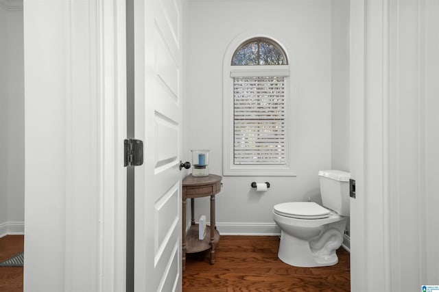 bathroom featuring hardwood / wood-style flooring and toilet