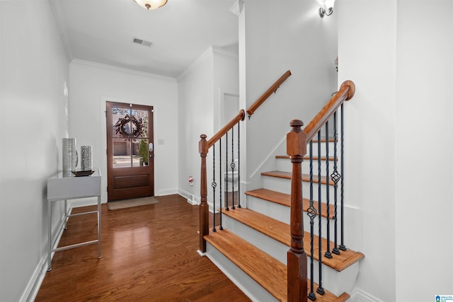 entryway featuring dark hardwood / wood-style floors and crown molding