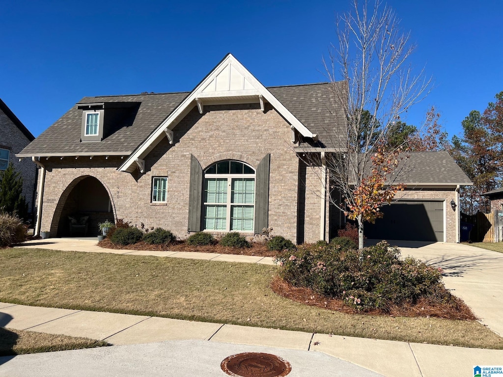 view of front of property with a garage and a front yard