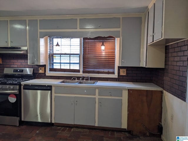 kitchen with decorative backsplash, appliances with stainless steel finishes, sink, and exhaust hood