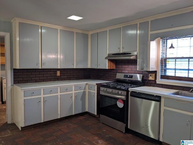 kitchen with tasteful backsplash, sink, and appliances with stainless steel finishes