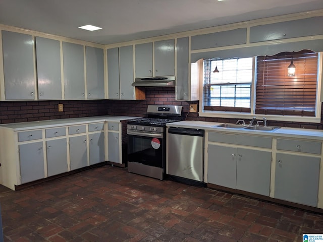 kitchen with tasteful backsplash, stainless steel appliances, sink, white cabinets, and hanging light fixtures