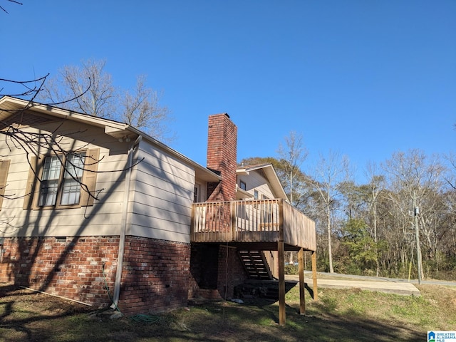 view of home's exterior with a wooden deck