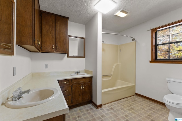 full bathroom with a textured ceiling, vanity, shower / bath combination, and toilet