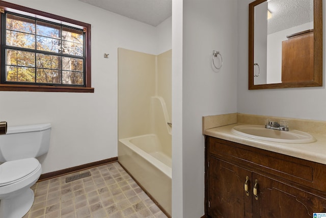 full bathroom with vanity, toilet, shower / bath combination, and a textured ceiling