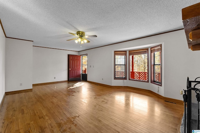 unfurnished living room with ceiling fan, a textured ceiling, and light hardwood / wood-style flooring