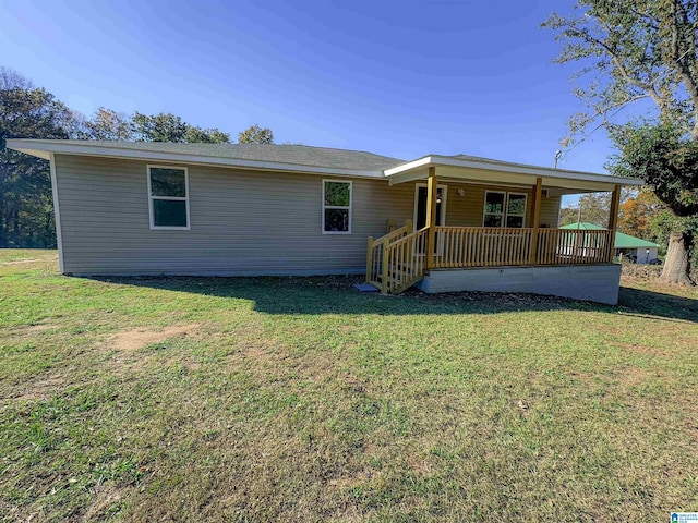 back of house with a lawn