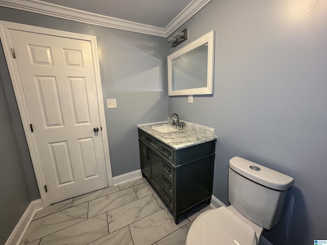 bathroom featuring toilet, vanity, and ornamental molding