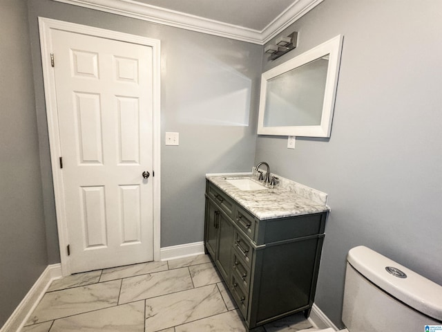 bathroom featuring vanity, toilet, and ornamental molding