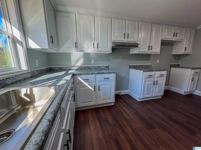 kitchen featuring white cabinets and dark hardwood / wood-style flooring