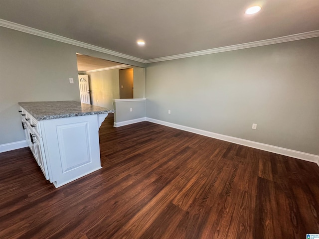 interior space with dark hardwood / wood-style floors and crown molding