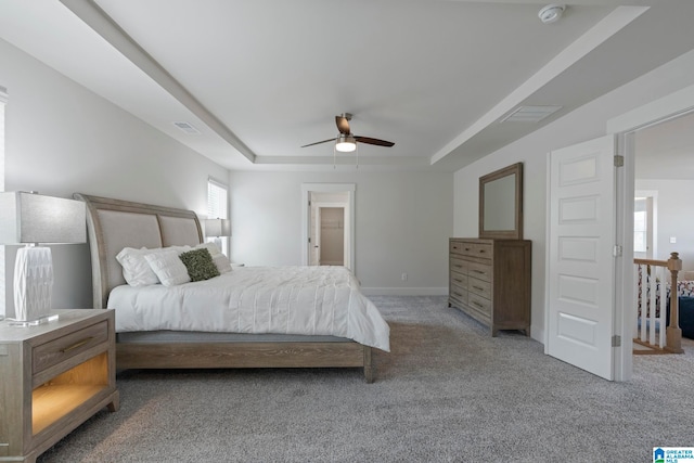 bedroom featuring carpet, ceiling fan, and a raised ceiling