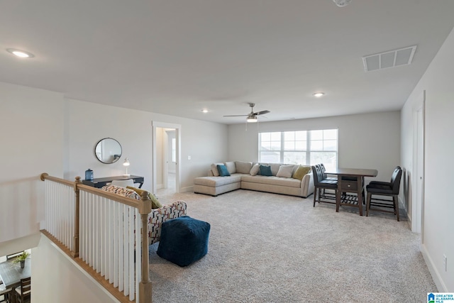 living room featuring carpet floors and ceiling fan