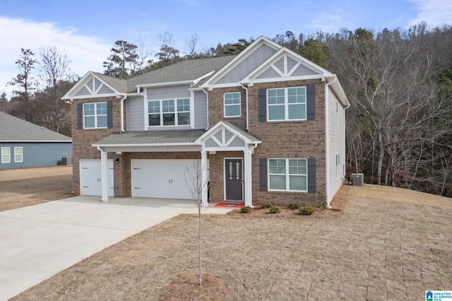 craftsman inspired home with cooling unit and a garage