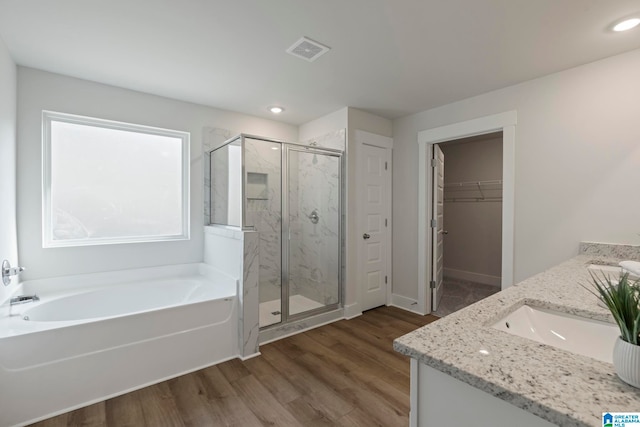 bathroom featuring vanity, separate shower and tub, and wood-type flooring