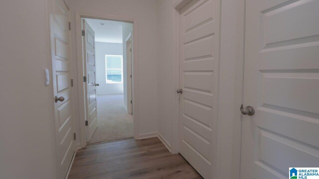 corridor with light hardwood / wood-style floors