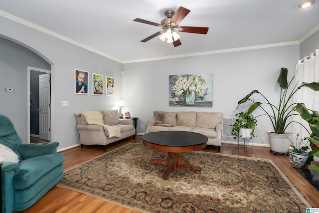 living room with hardwood / wood-style floors, ceiling fan, and crown molding