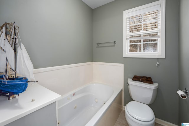 bathroom with tile patterned floors, toilet, and a bath