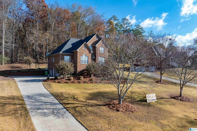 view of side of property with a garage and a lawn