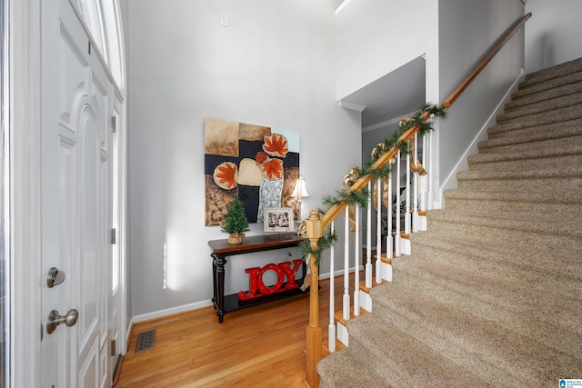 entryway with hardwood / wood-style flooring and ornamental molding