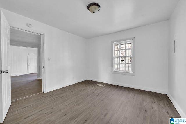 empty room featuring dark wood-type flooring