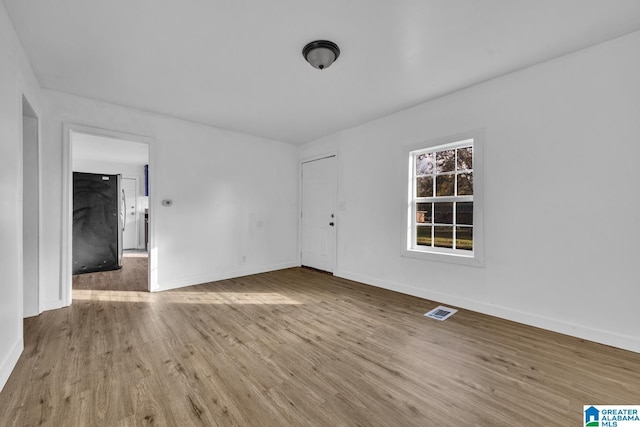 unfurnished room featuring hardwood / wood-style flooring