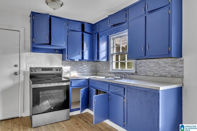 kitchen with decorative backsplash, light hardwood / wood-style flooring, blue cabinetry, and stainless steel electric range