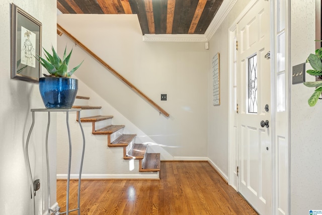 foyer entrance featuring wood ceiling, crown molding, and wood-type flooring