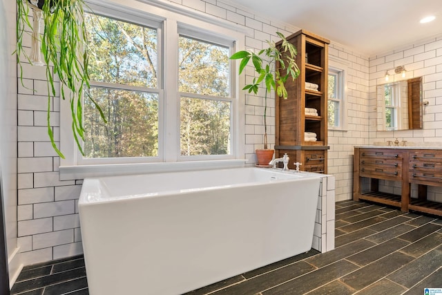 bathroom featuring vanity, hardwood / wood-style flooring, and a bathtub