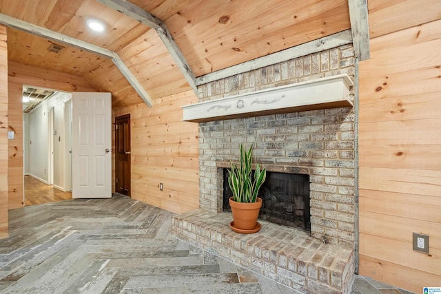 unfurnished living room featuring hardwood / wood-style floors, wood walls, lofted ceiling, a fireplace, and wood ceiling