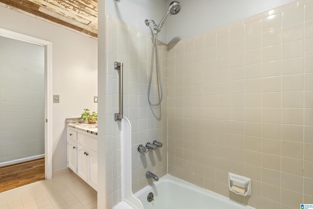 bathroom featuring vanity, tile patterned floors, and tiled shower / bath combo