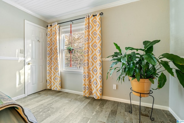 foyer with hardwood / wood-style floors and crown molding