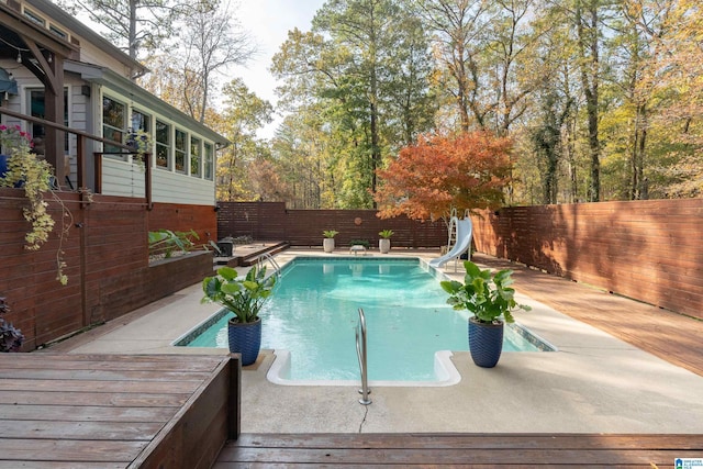 view of pool featuring a patio area and a water slide