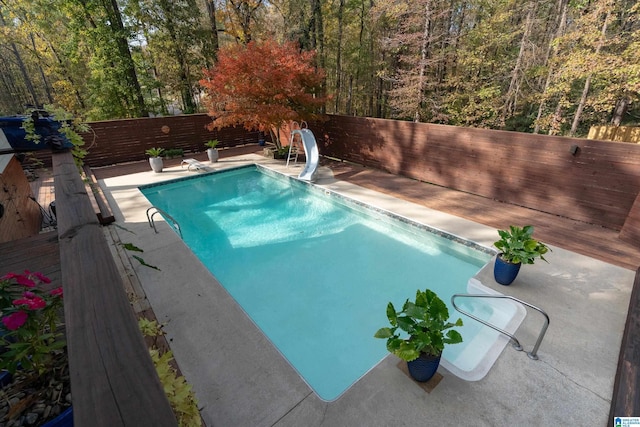 view of pool with a patio and a water slide