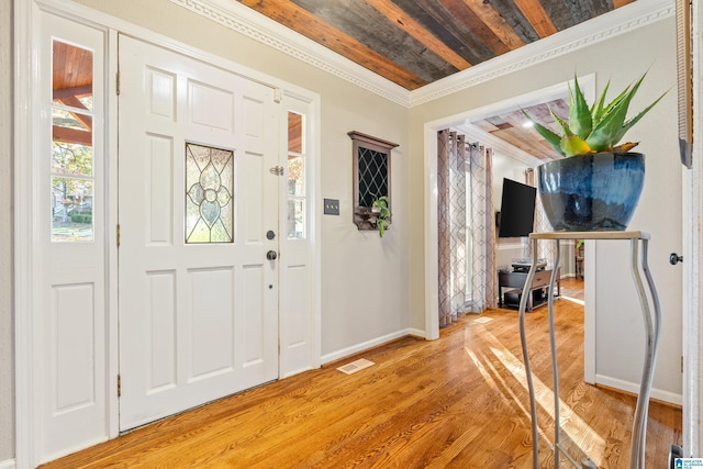 entryway featuring crown molding, wooden ceiling, and wood-type flooring