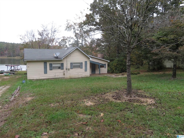 exterior space featuring a water view and a front yard