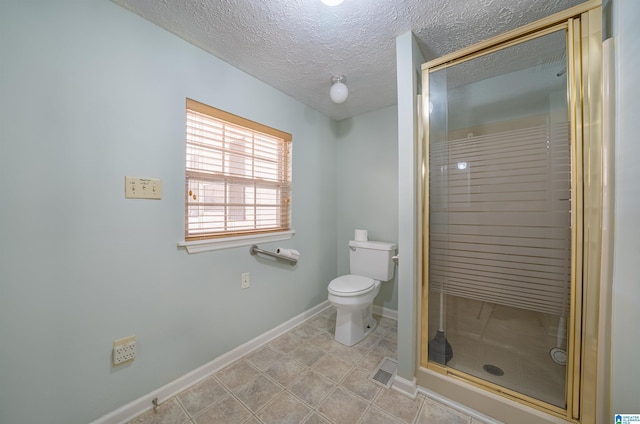 bathroom with toilet, a textured ceiling, and walk in shower