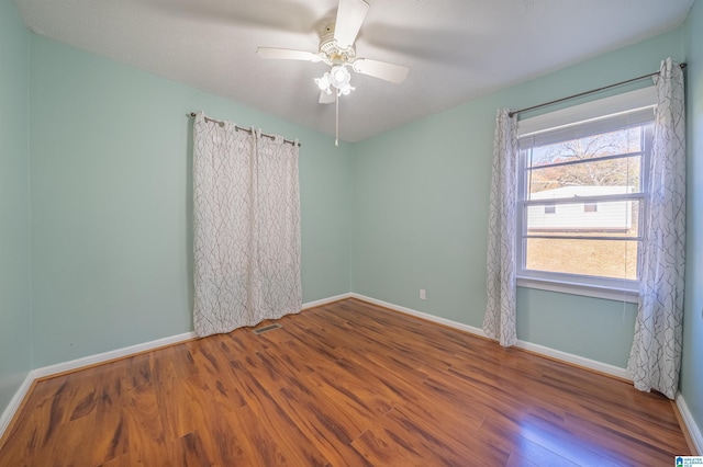 empty room with ceiling fan and wood-type flooring