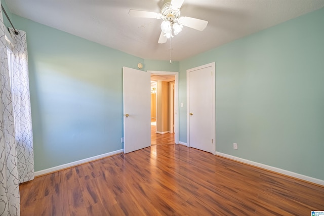 spare room featuring ceiling fan and hardwood / wood-style flooring