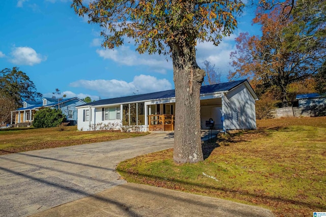 ranch-style home featuring a front yard and a carport