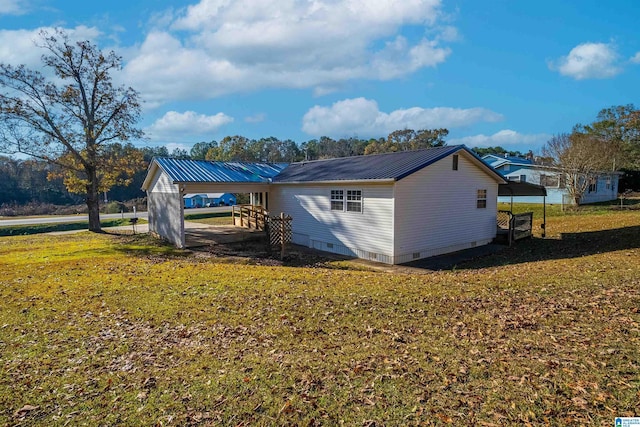 view of property exterior with a yard and a carport