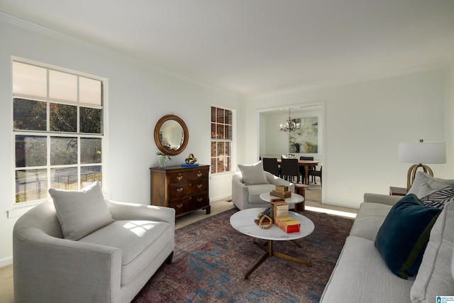 living room with carpet flooring, a wealth of natural light, ornamental molding, and a notable chandelier