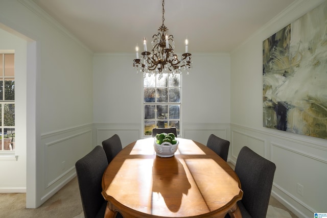 dining space featuring an inviting chandelier, light colored carpet, and ornamental molding